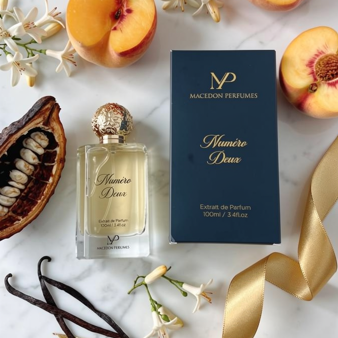 Macedon Perfumes bottle and packaging with peaches and flowers on a marble surface