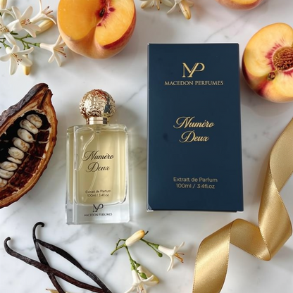 Macedon Perfumes bottle and packaging with peaches and flowers on a marble surface