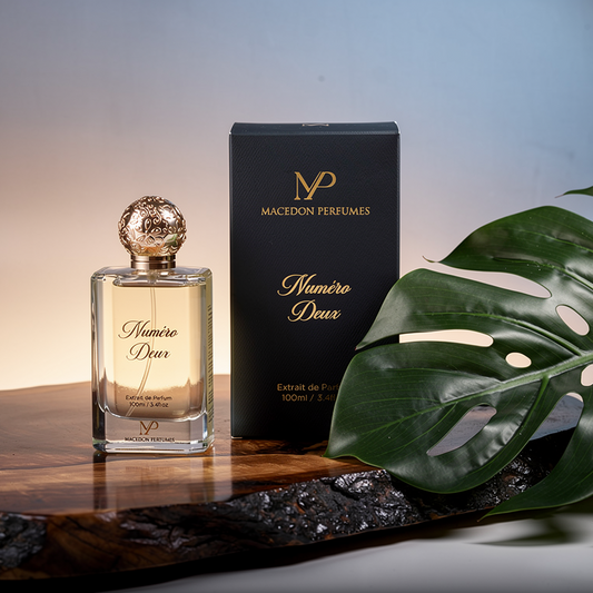 Perfume bottle and packaging with a leaf on a wooden surface