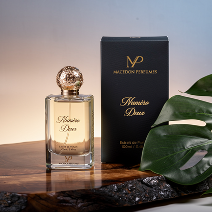 Perfume bottle and packaging with a leaf on a wooden surface