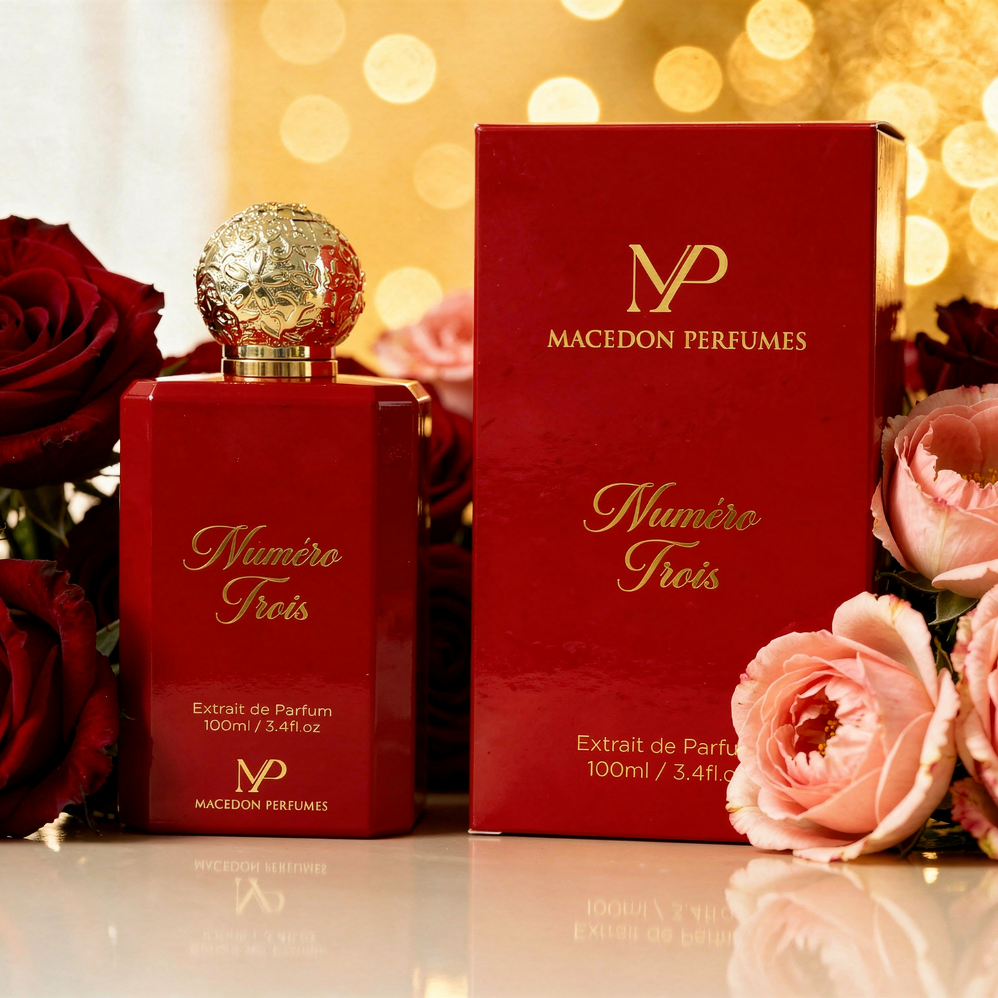 Red Macedon Perfumes bottle and box with roses on a reflective surface